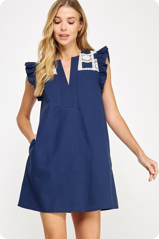  linen mini dress with crochet yoke detailing, flutter sleeves, and side pockets 