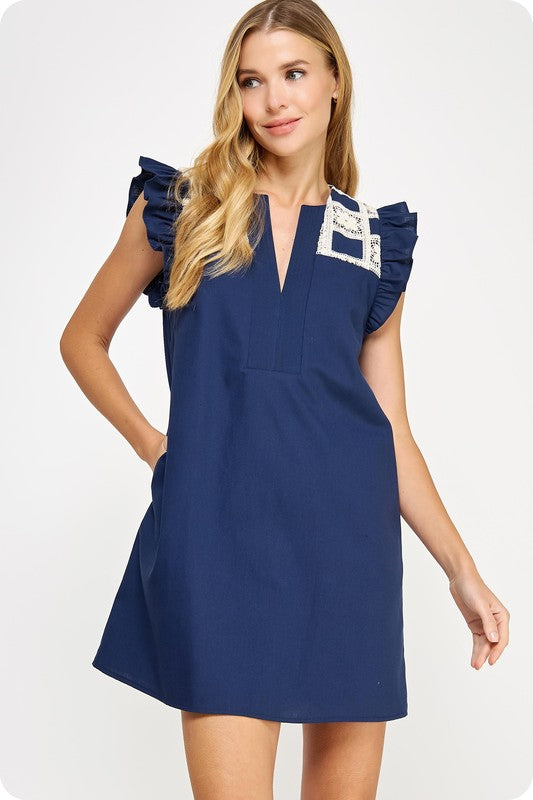  linen mini dress with crochet yoke detailing, flutter sleeves, and side pockets 