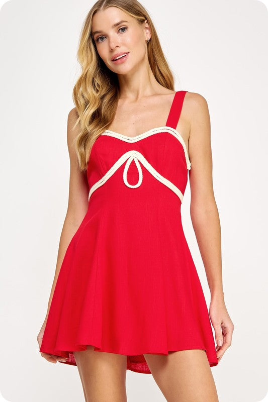 linen babydoll mini dress featuring braided trim detailing and a flattering sweetheart neckline