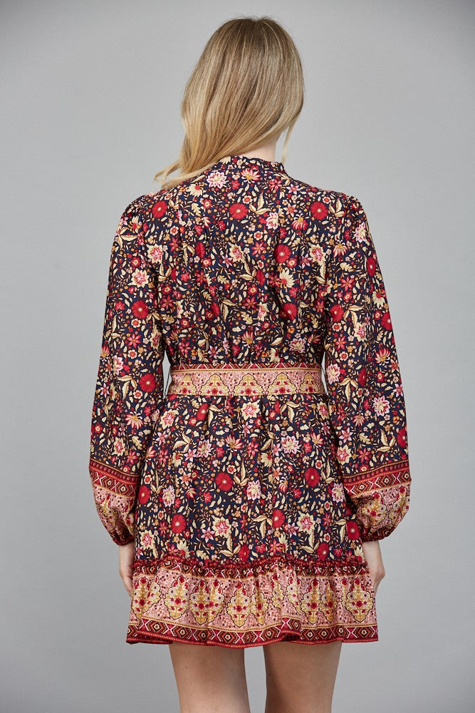 Chic and flattering, the Delphine dress features a striking border print and a belted button-down silhouette.