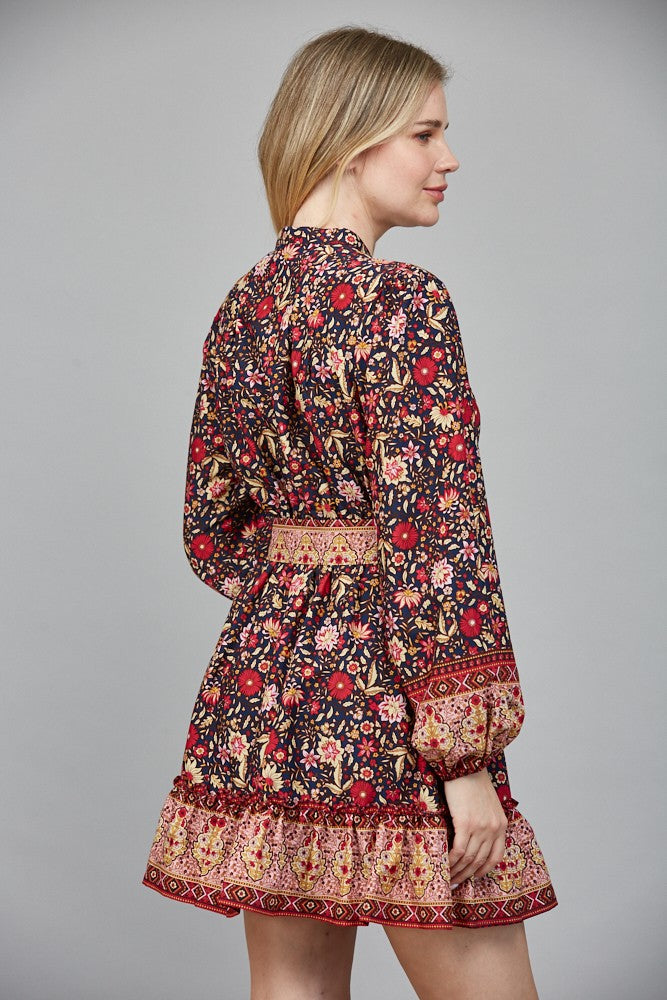 Chic and flattering, the Delphine dress features a striking border print and a belted button-down silhouette.