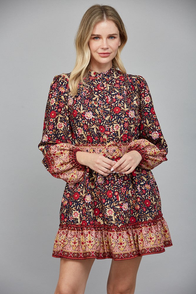 Chic and flattering, the Delphine dress features a striking border print and a belted button-down silhouette.