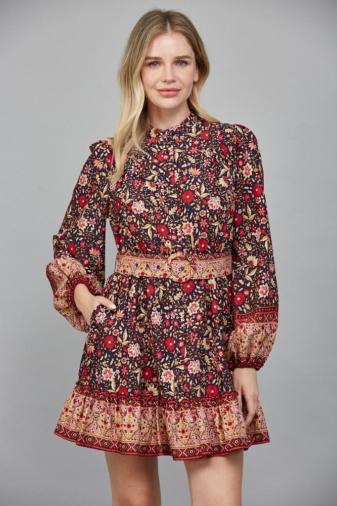 Chic and flattering, the Delphine dress features a striking border print and a belted button-down silhouette.