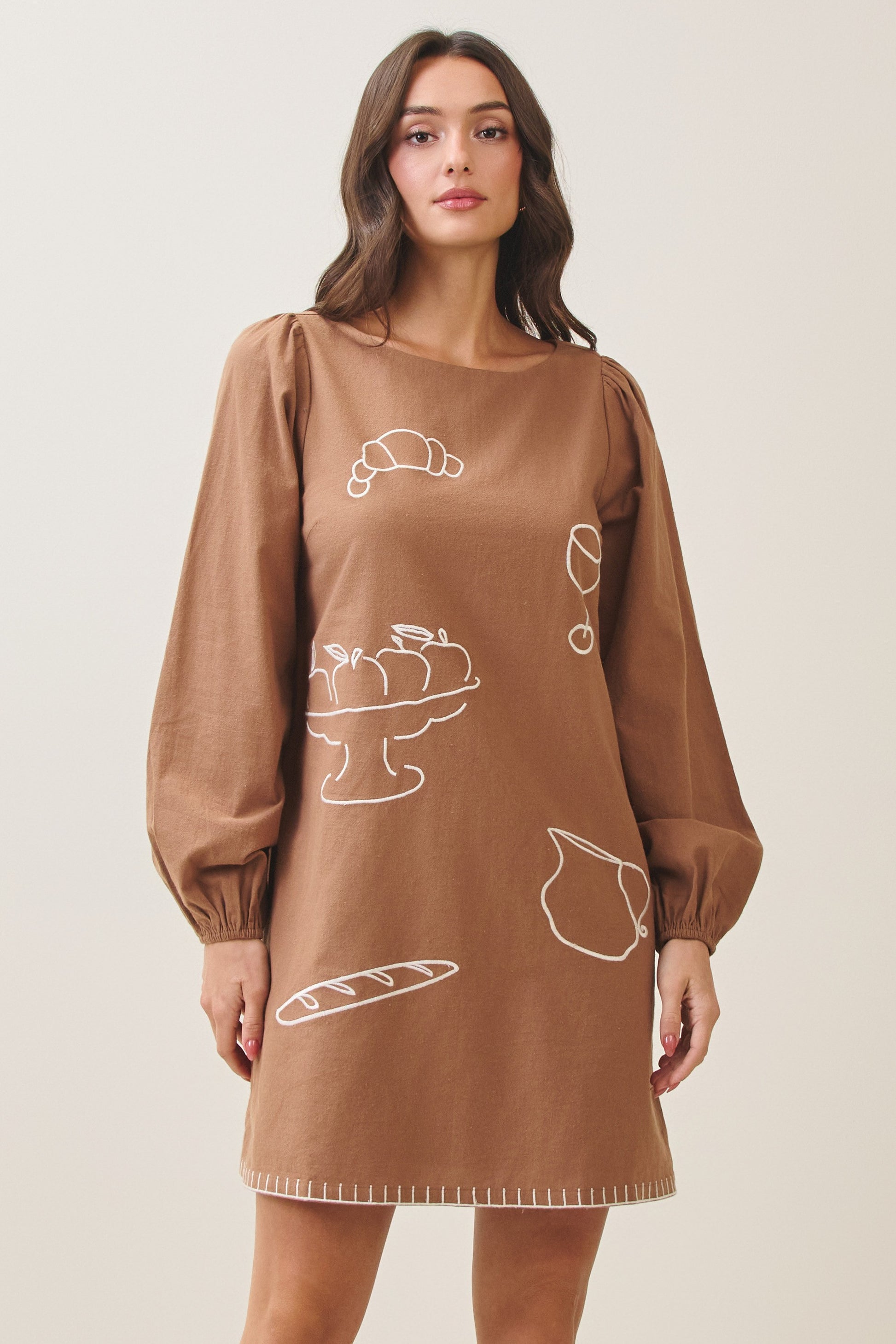 100% cotton embroidered mini dress featuring long volume sleeves, decorative whipstitch detailing, and a relaxed feminine silhouette.