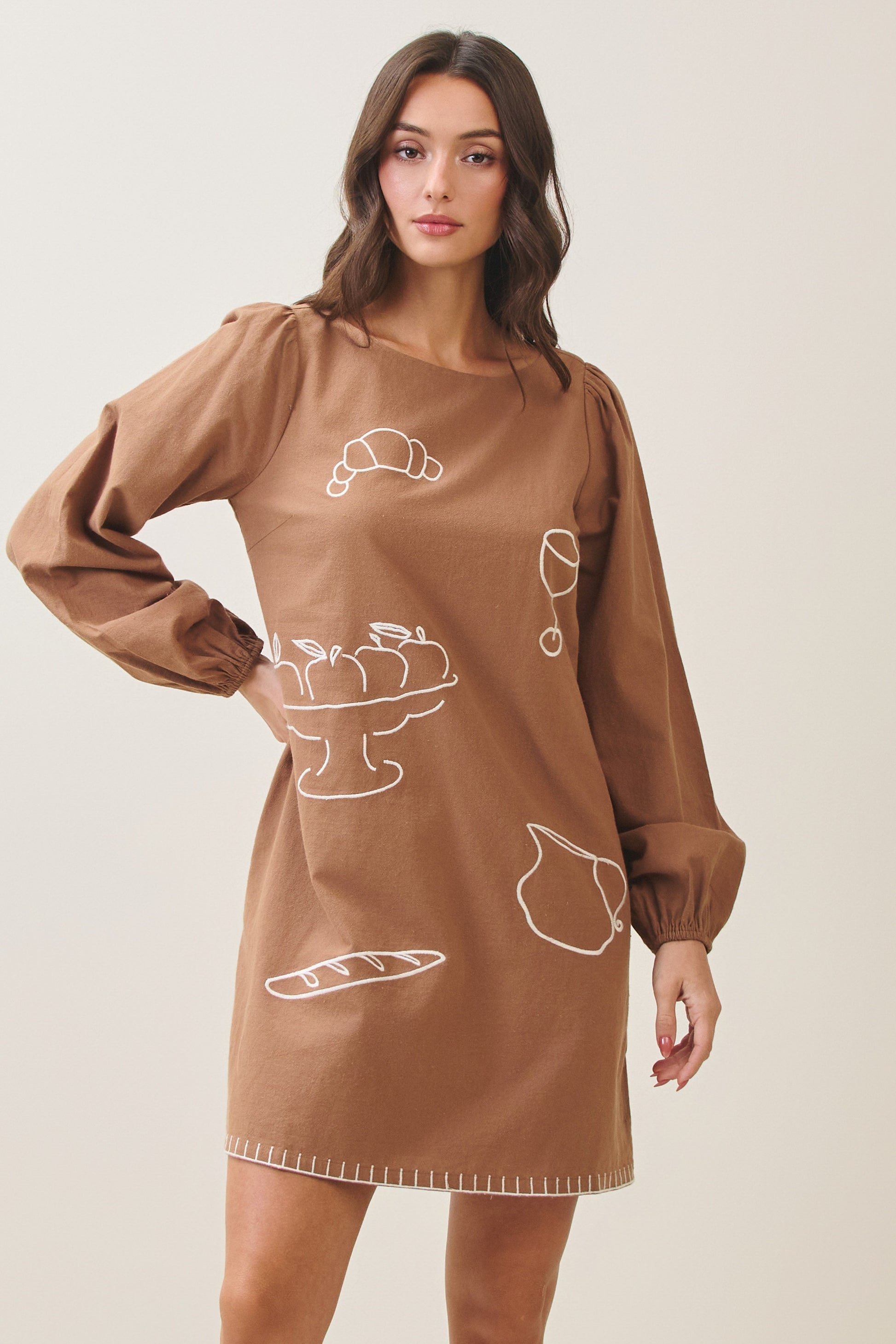 100% cotton embroidered mini dress featuring long volume sleeves, decorative whipstitch detailing, and a relaxed feminine silhouette.