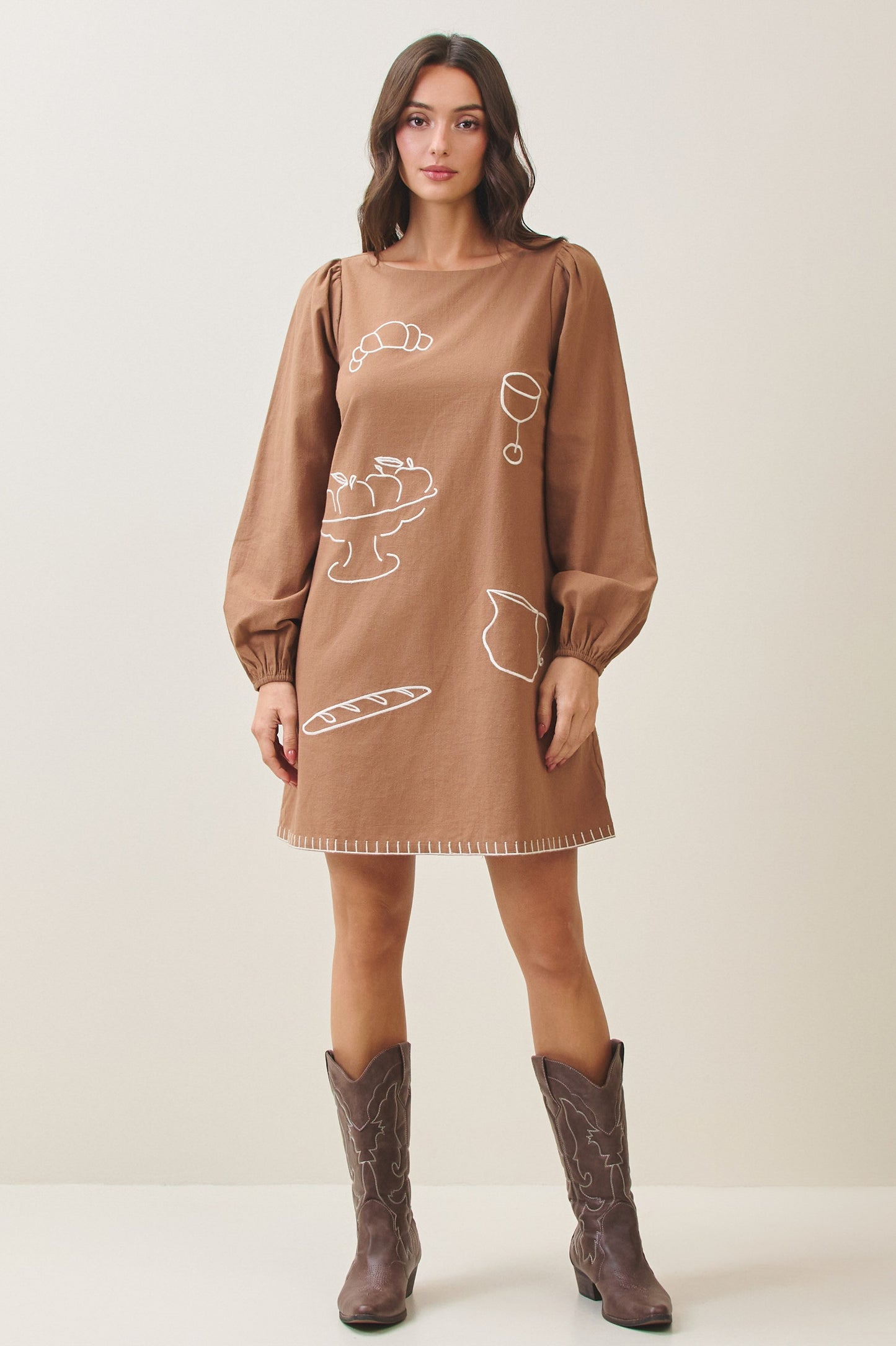 100% cotton embroidered mini dress featuring long volume sleeves, decorative whipstitch detailing, and a relaxed feminine silhouette.