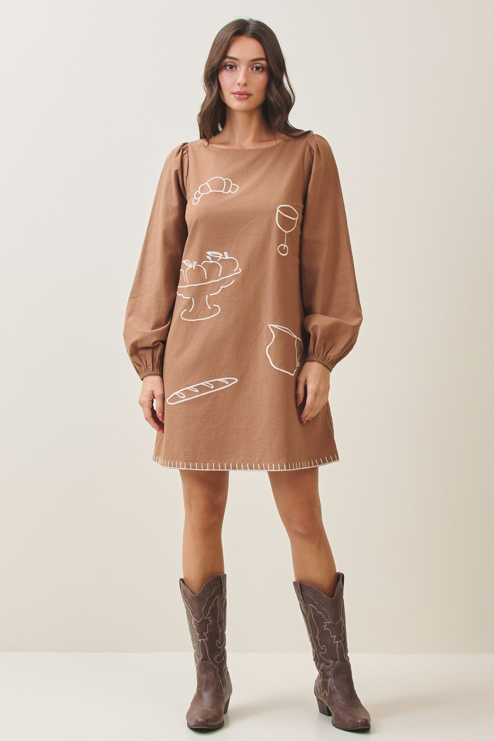 100% cotton embroidered mini dress featuring long volume sleeves, decorative whipstitch detailing, and a relaxed feminine silhouette.