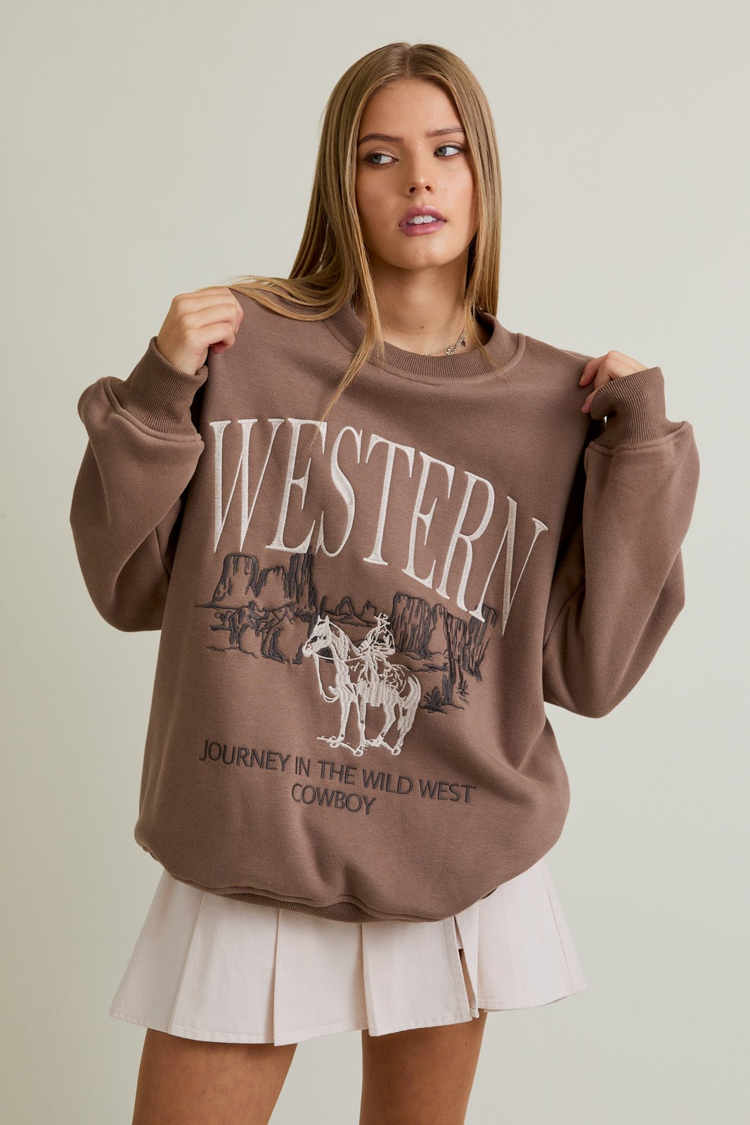 The Cheyenne&nbsp;sweatshirt pairs oversized comfort with a bold “Cowboy” embroidered design for western-inspired style.