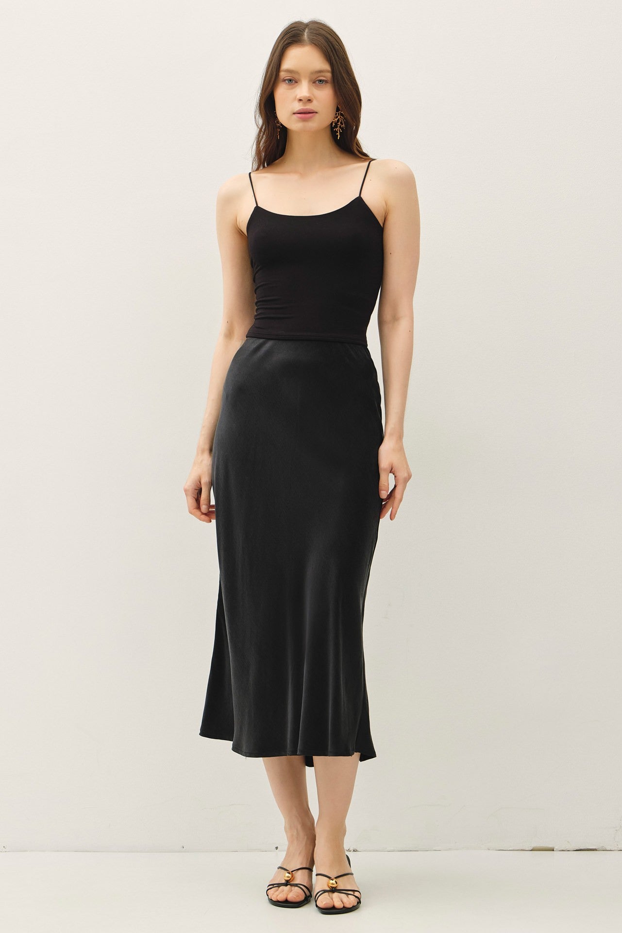 Soft, flowy, and flattering—the Rowena midi skirt brings luxe texture to an everyday silhouette.