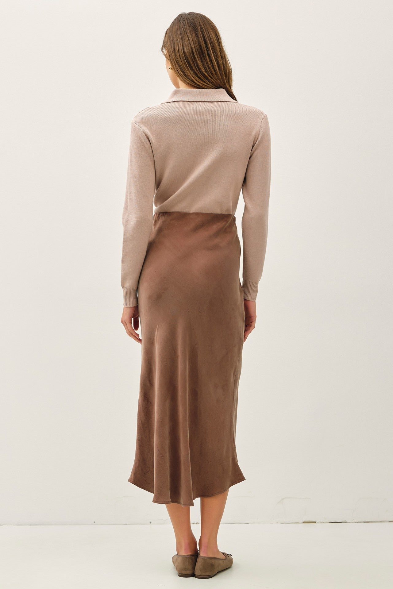 Soft, flowy, and flattering—the Rowena midi skirt brings luxe texture to an everyday silhouette.