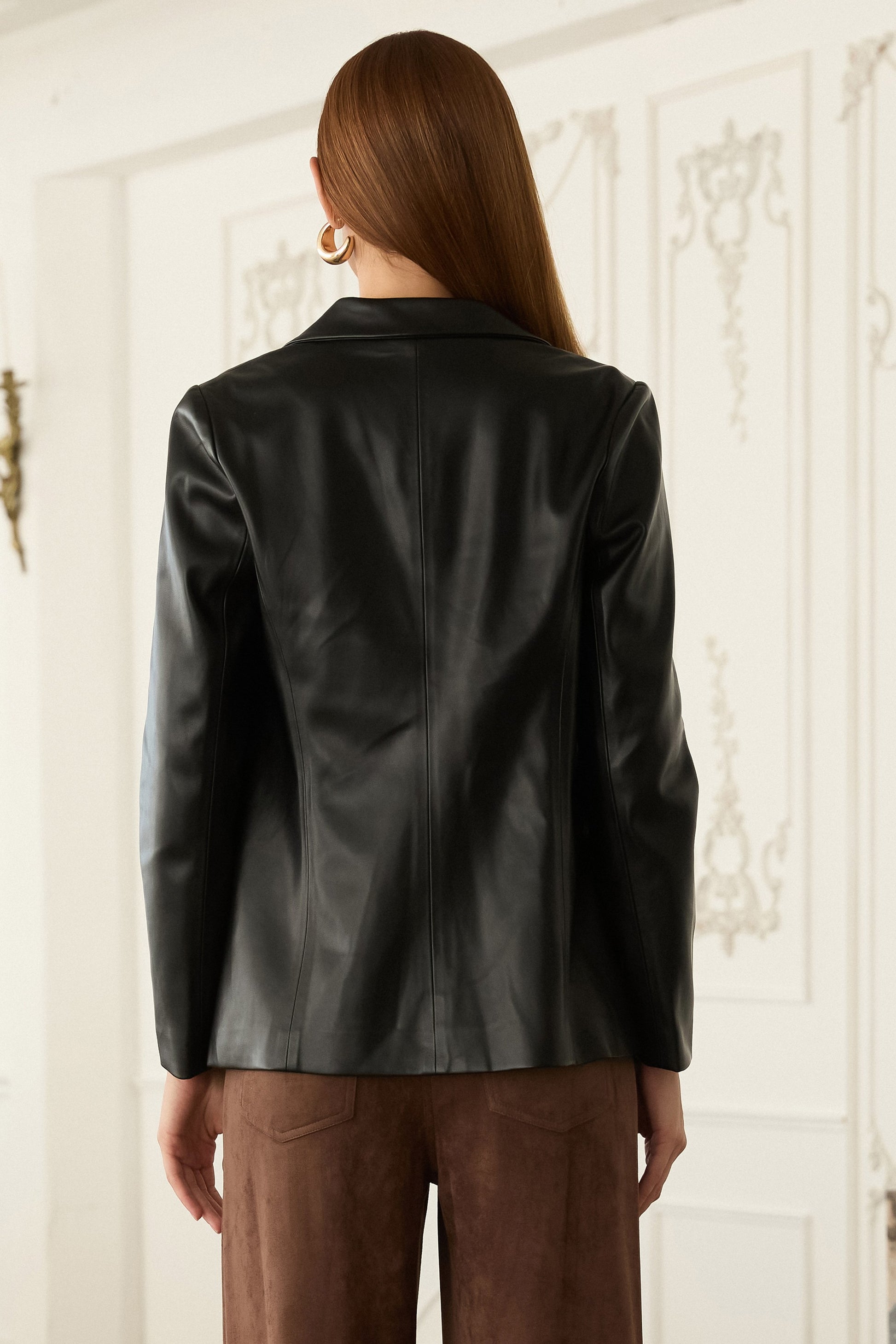 The Vivienne blazer brings sleek sophistication with its supple faux leather and modern open-front design.
