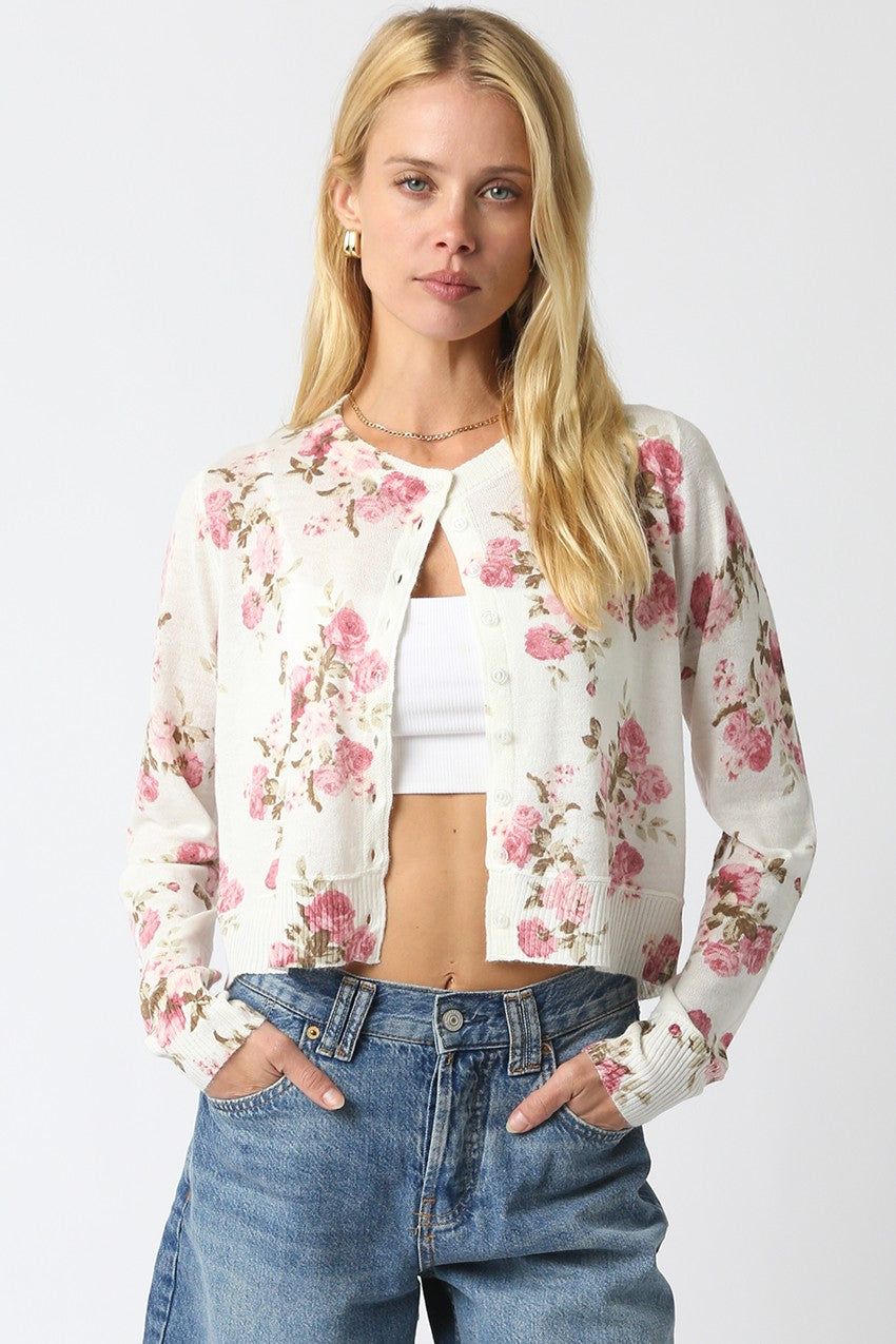 Cropped floral knit cardigan with vintage flower pattern, button front, and ribbed hem.
