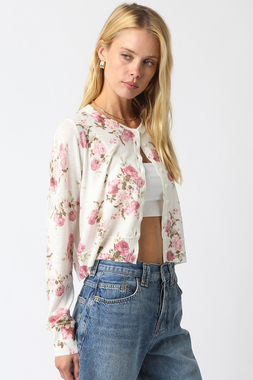Cropped floral knit cardigan with vintage flower pattern, button front, and ribbed hem.