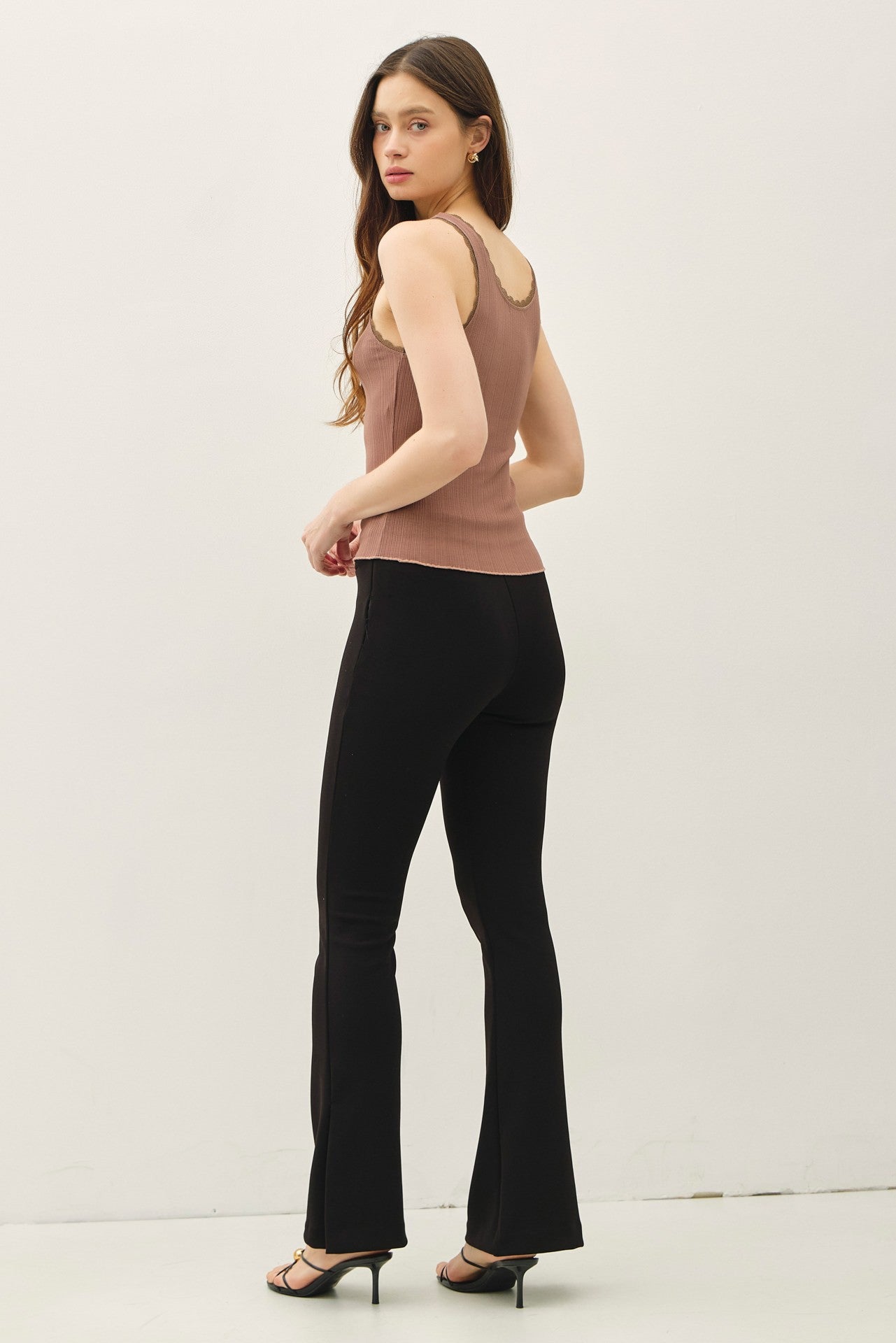 Lace trimmed ribbed tank top with scoop neckline.