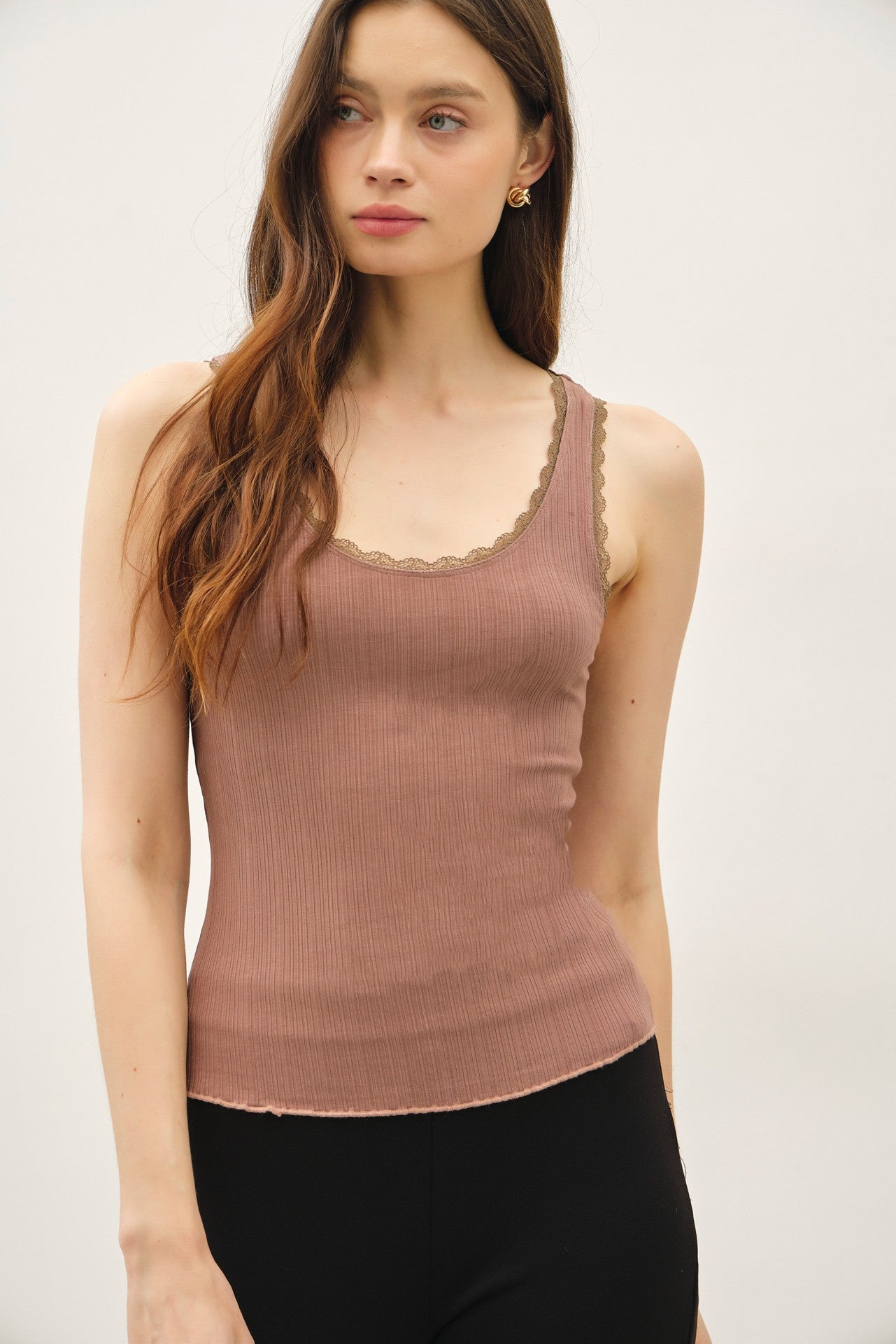 Lace trimmed ribbed tank top with scoop neckline.