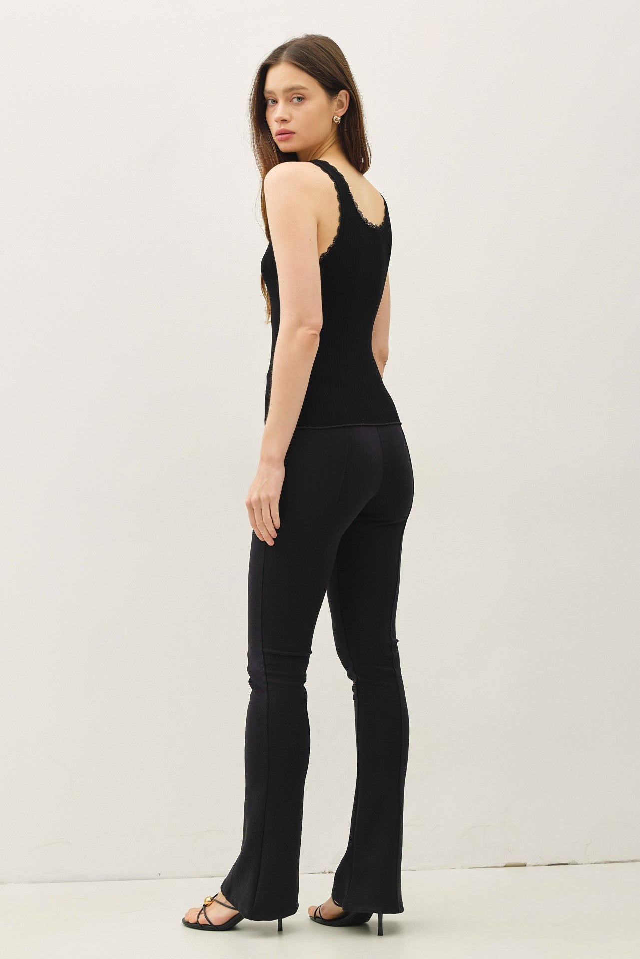 Lace trimmed ribbed tank top with scoop neckline.