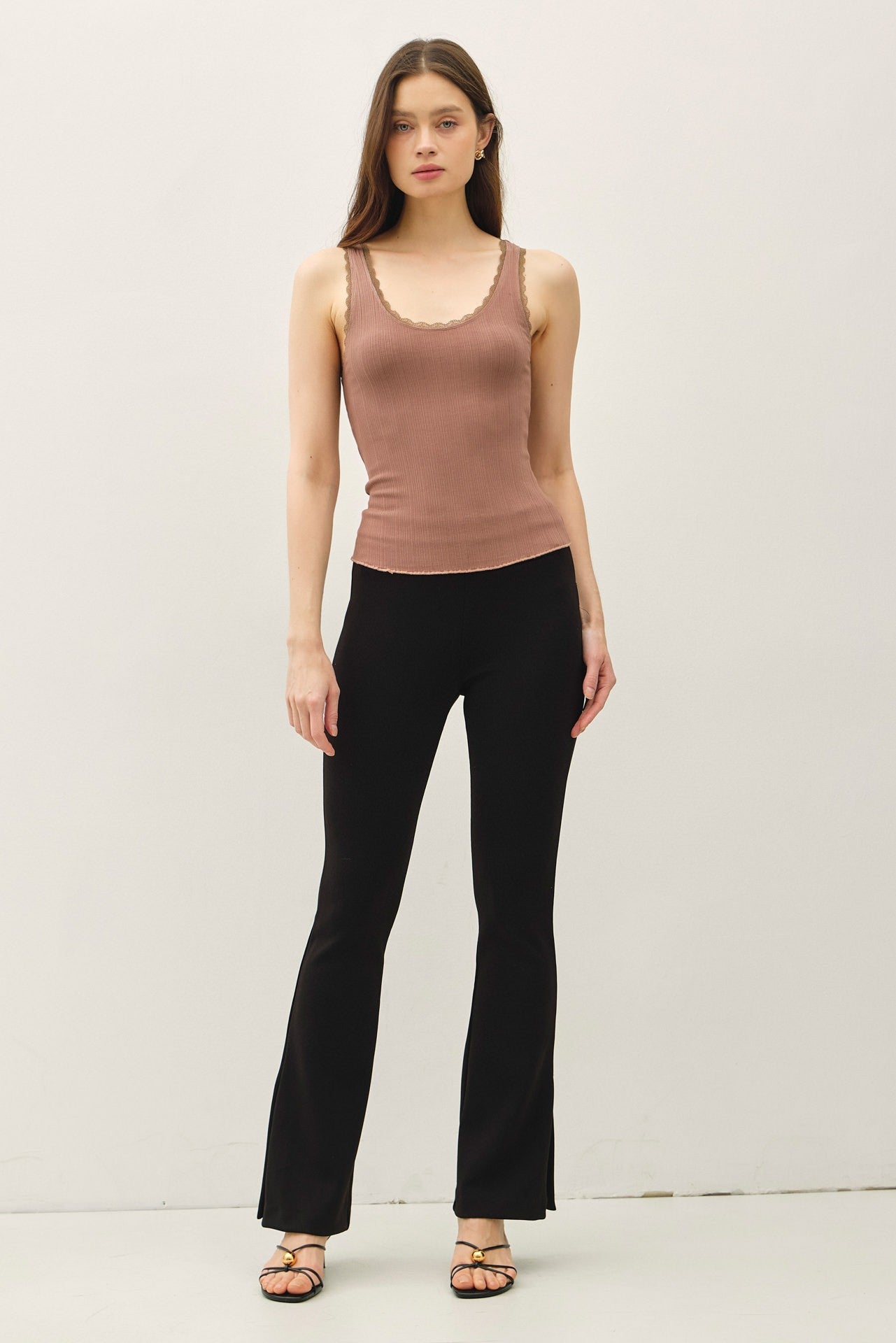 Lace trimmed ribbed tank top with scoop neckline.