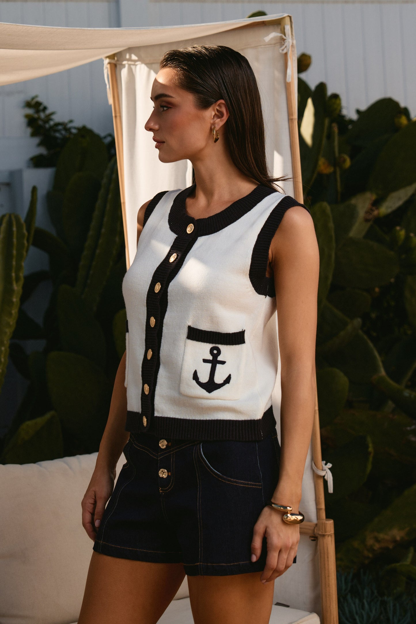 Contrast Anchor Knit Vest features nautical-inspired contrast trim, gold button accents, and a classic sleeveless silhouette