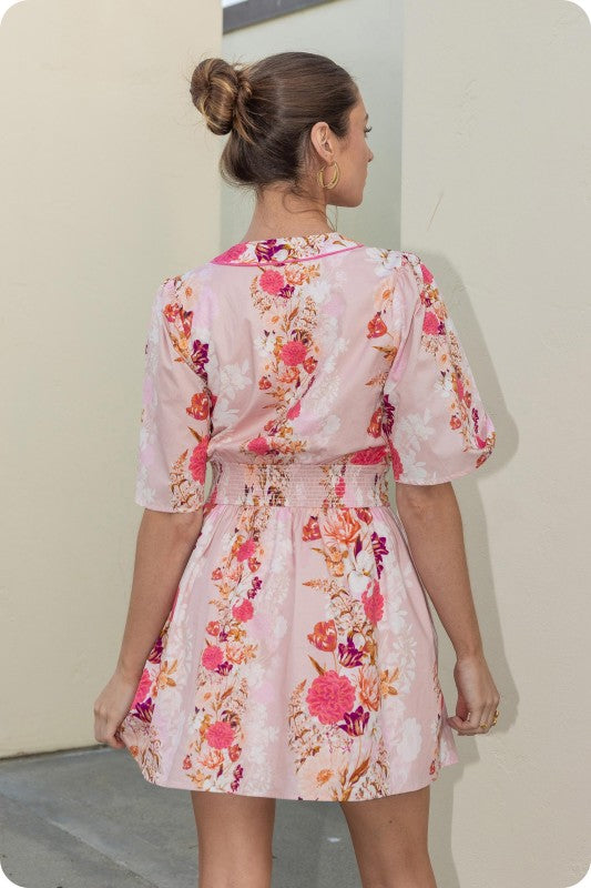 floral mini dress with contrast piping, flutter sleeves, and a cinched smocked waist