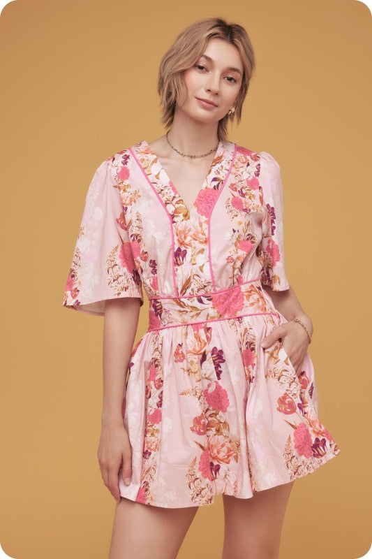 floral mini dress with contrast piping, flutter sleeves, and a cinched smocked waist