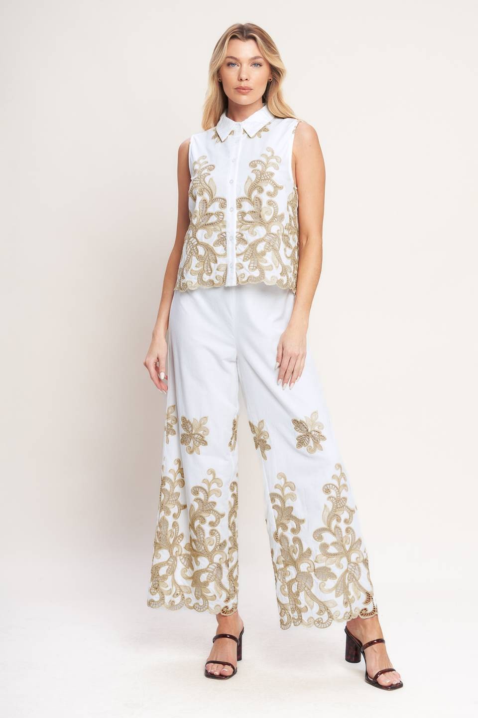 Embroidered Sleeveless Top features delicate embroidery, a classic collar, and a polished button-down front