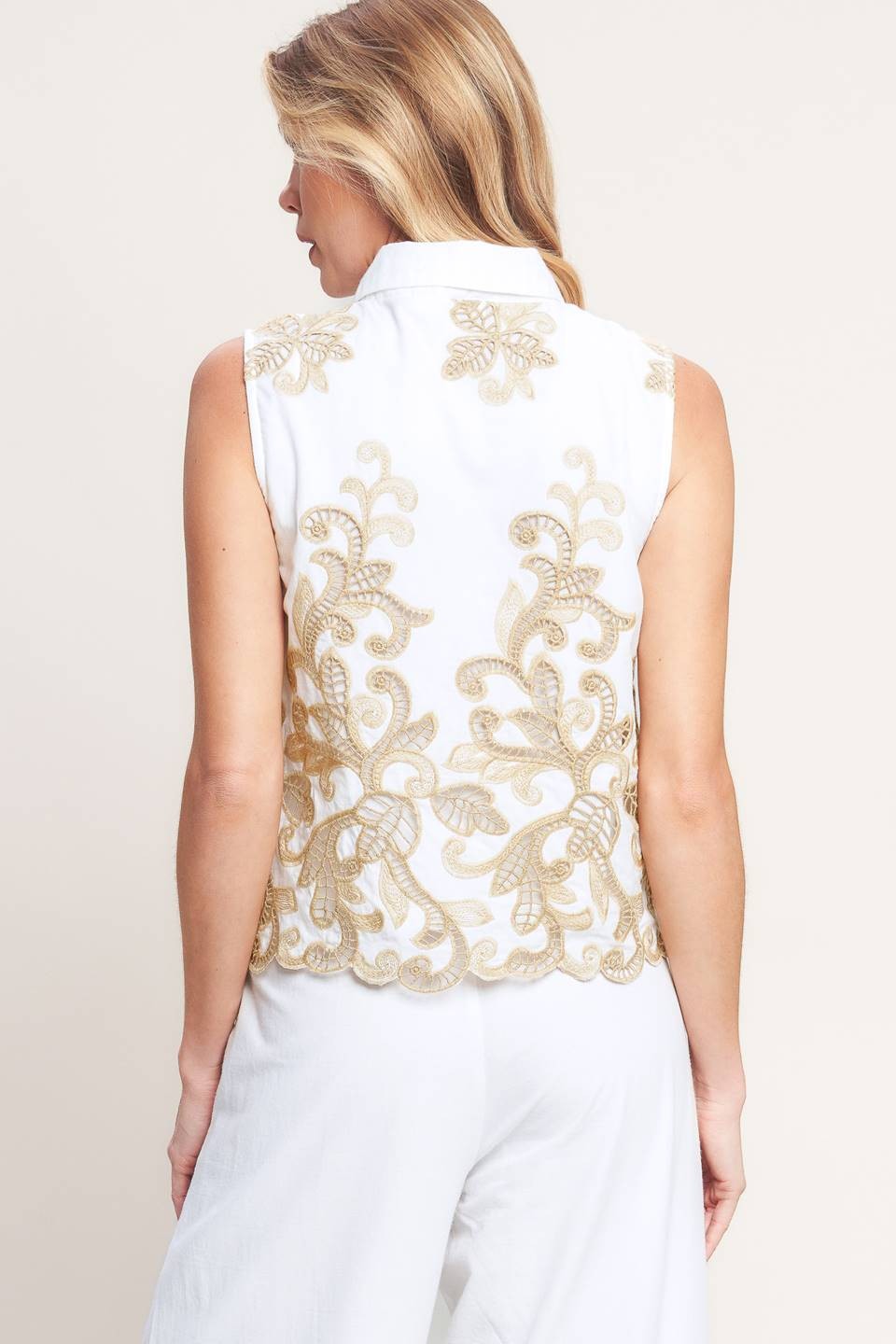 Embroidered Sleeveless Top features delicate embroidery, a classic collar, and a polished button-down front