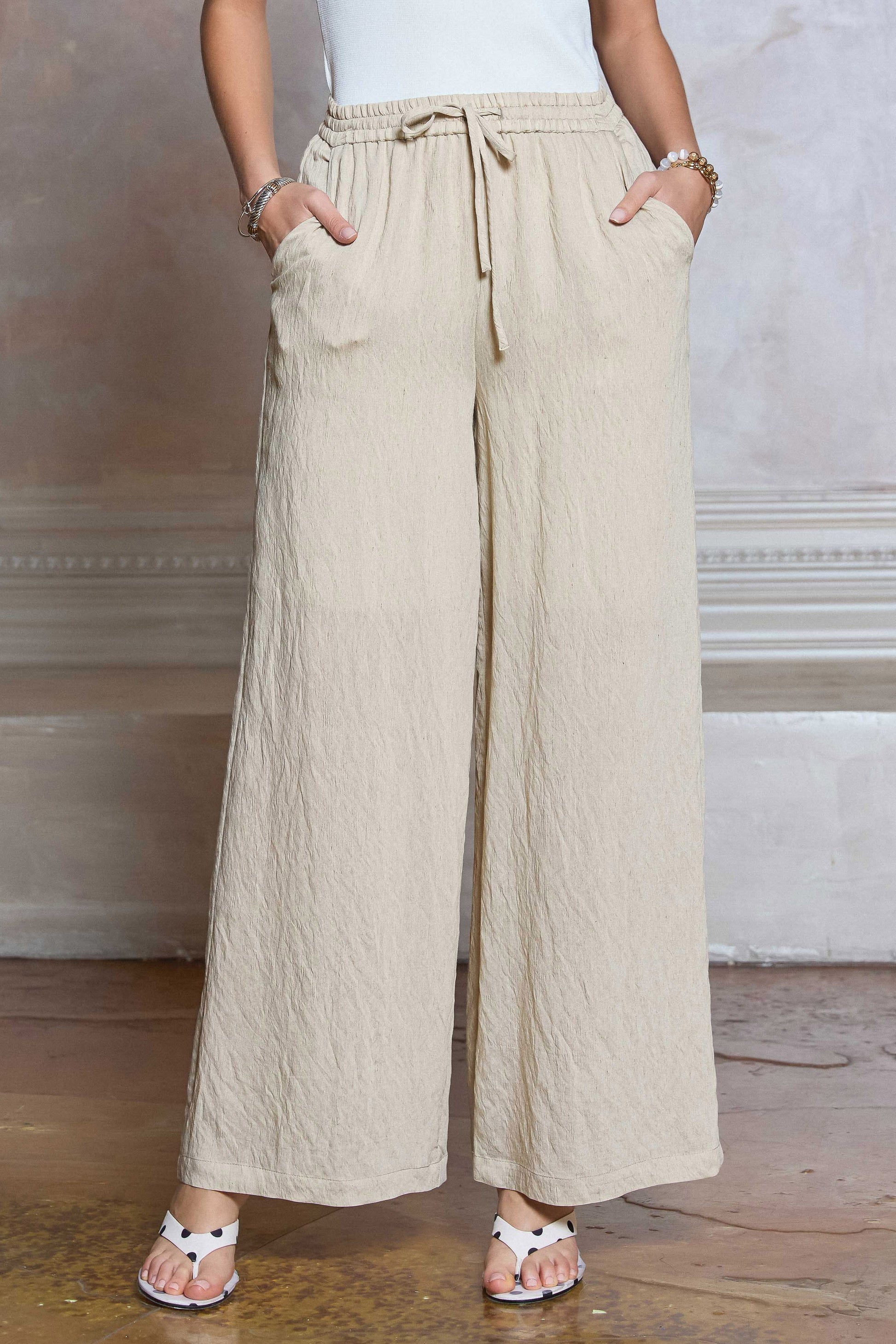 Drawstring Pants feature a wide leg silhouette, elastic waistband, and lightweight textured fabric
