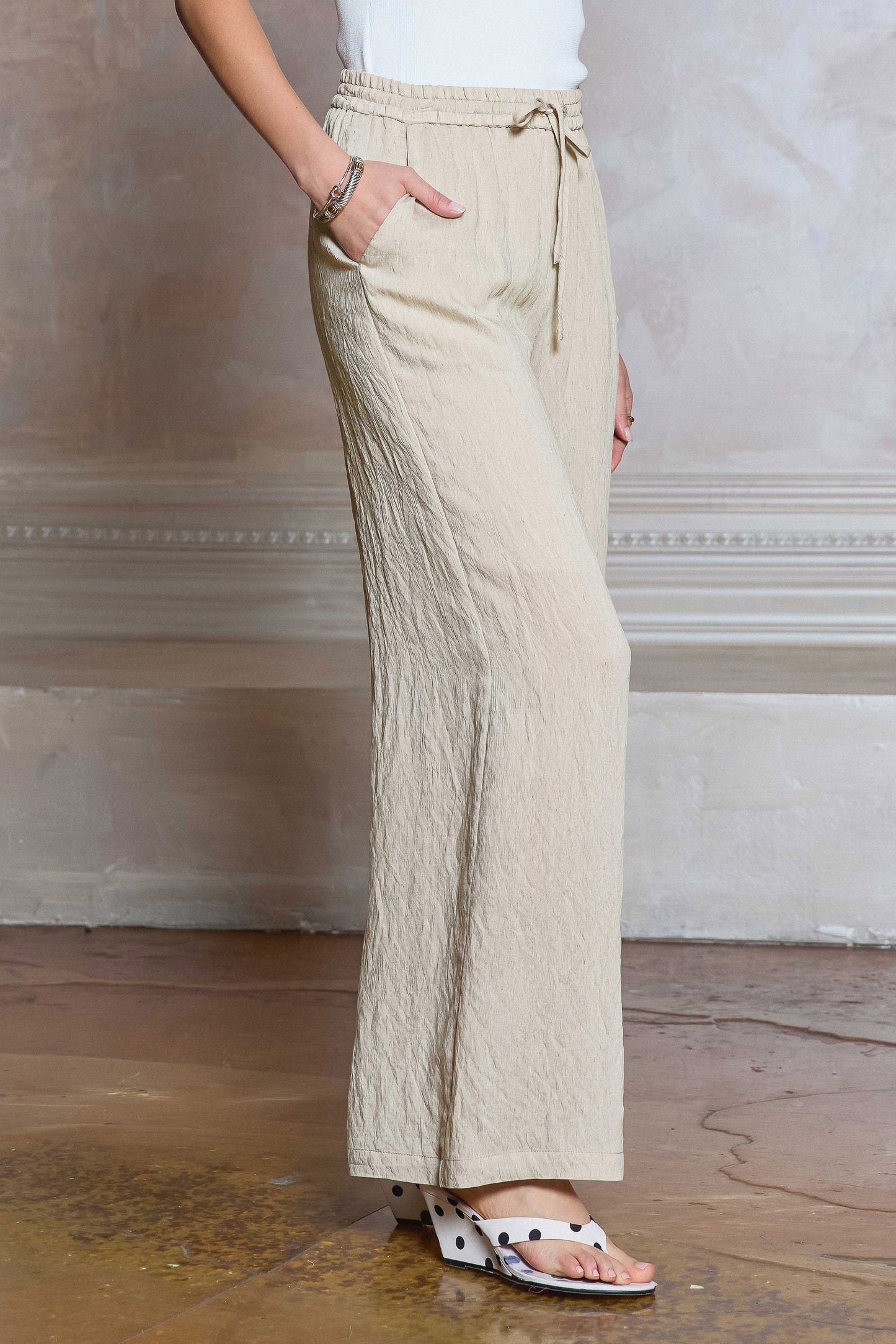 Drawstring Pants feature a wide leg silhouette, elastic waistband, and lightweight textured fabric