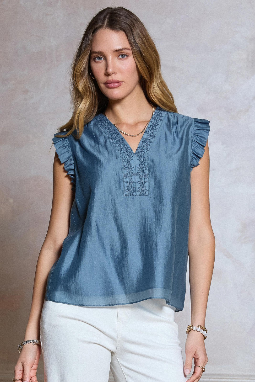  Embroidered Ruffle Blouse features delicate floral embroidery, a flattering V-neckline, and soft ruffled sleeves 