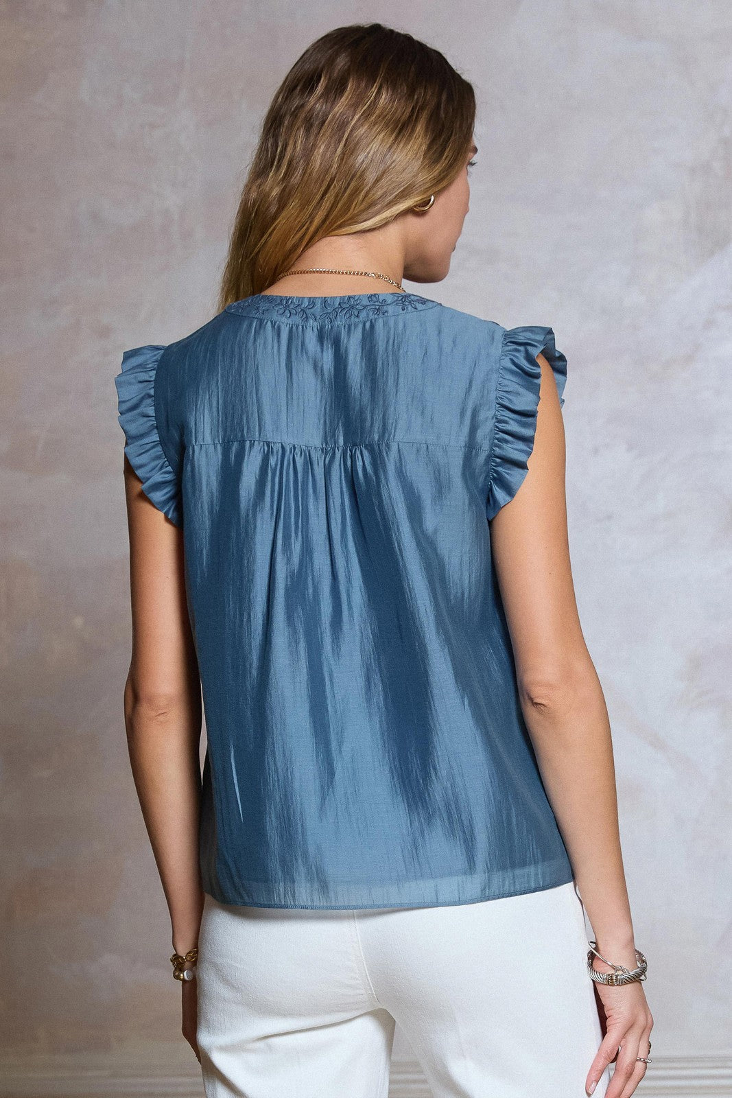  Embroidered Ruffle Blouse features delicate floral embroidery, a flattering V-neckline, and soft ruffled sleeves 