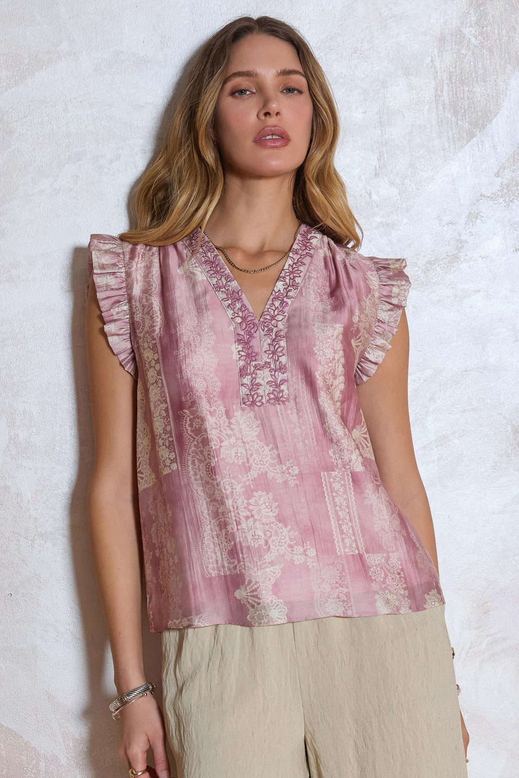Floral Embroidered Blouse features a lace-inspired floral print, delicate embroidery, and ruffled sleeves