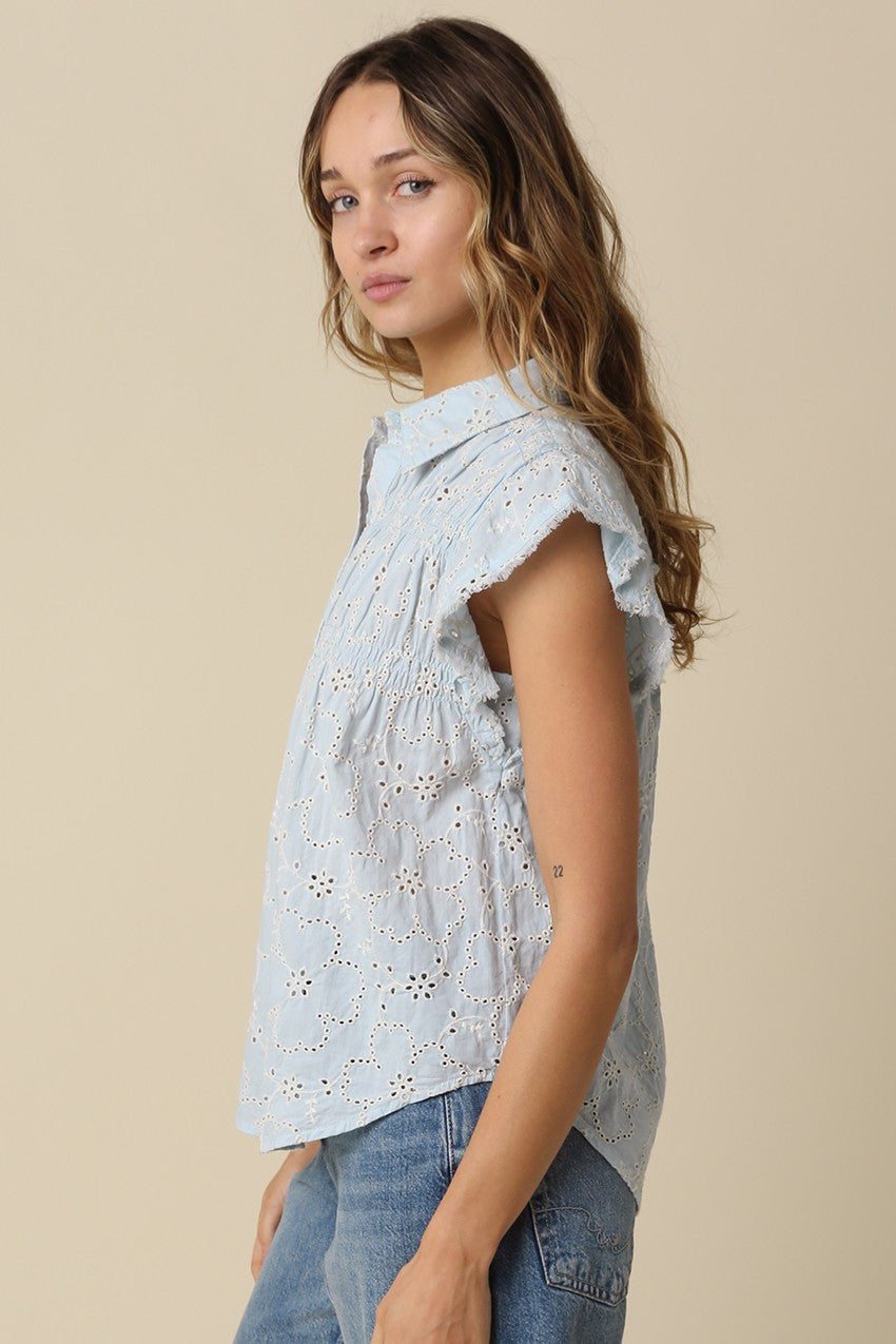 Anne pintuck flutter sleeve top featuring vertical pintuck detail, front button closure, and soft cap sleeves.
