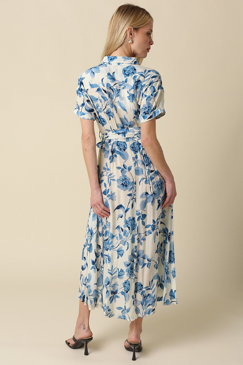 Blue floral belted maxi dress with collared button-down front, short rolled sleeves, and adjustable waist tie.