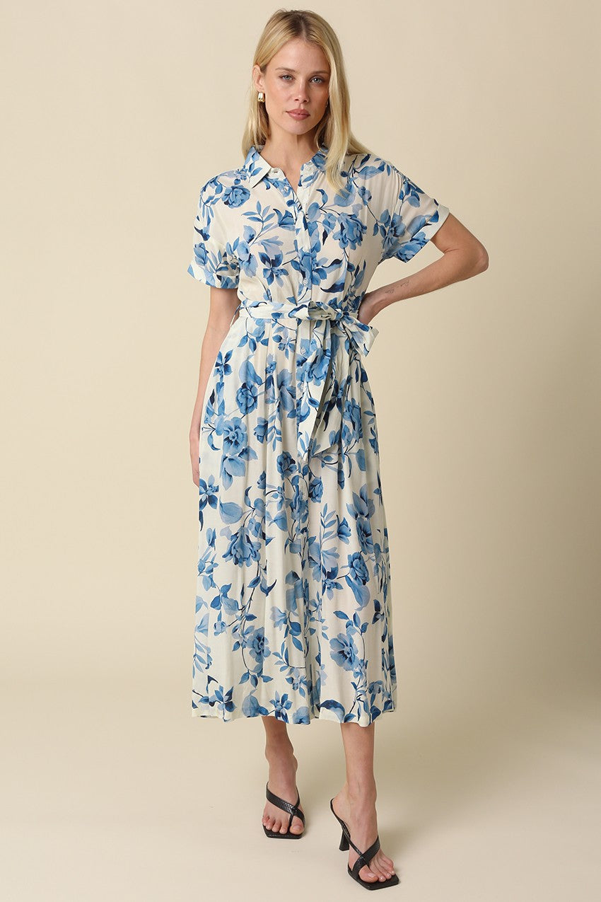 Blue floral belted maxi dress with collared button-down front, short rolled sleeves, and adjustable waist tie.