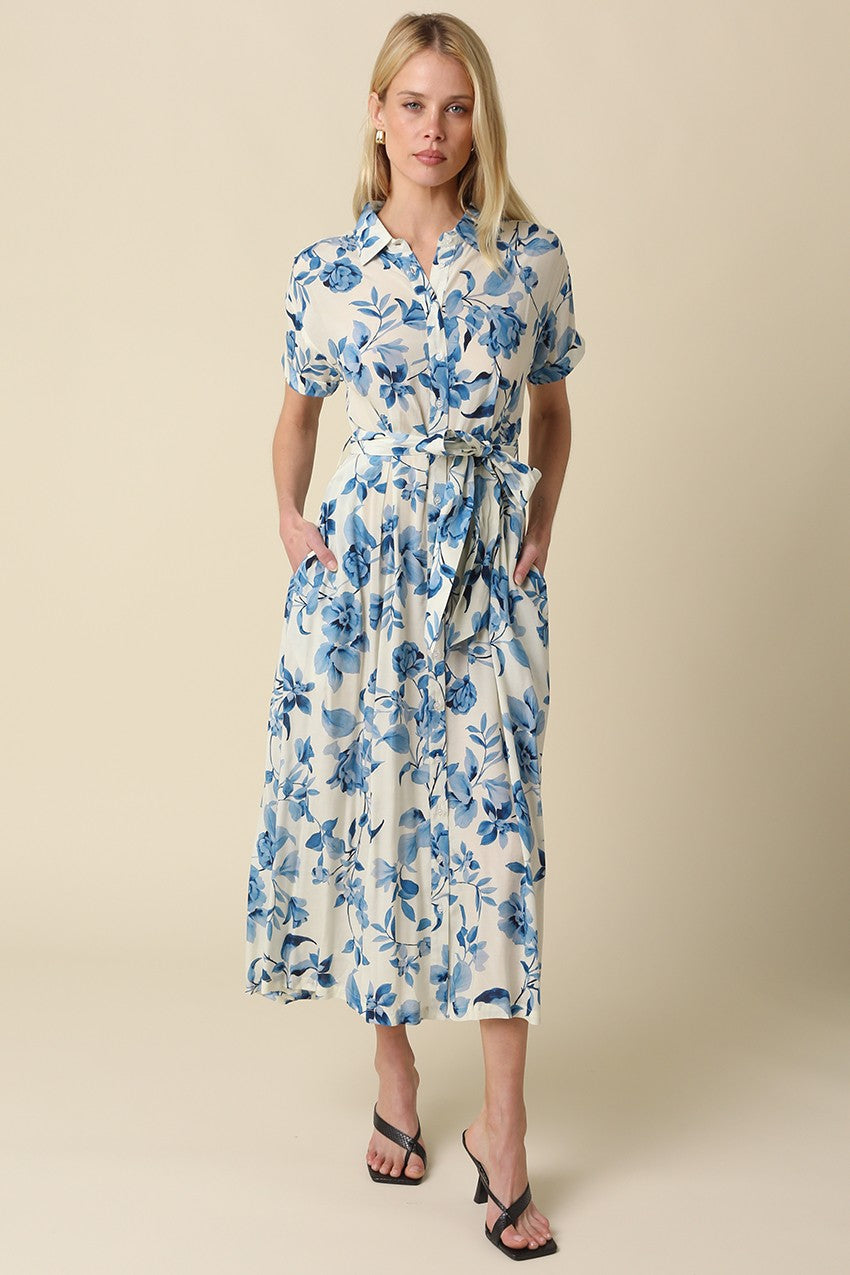 Blue floral belted maxi dress with collared button-down front, short rolled sleeves, and adjustable waist tie.