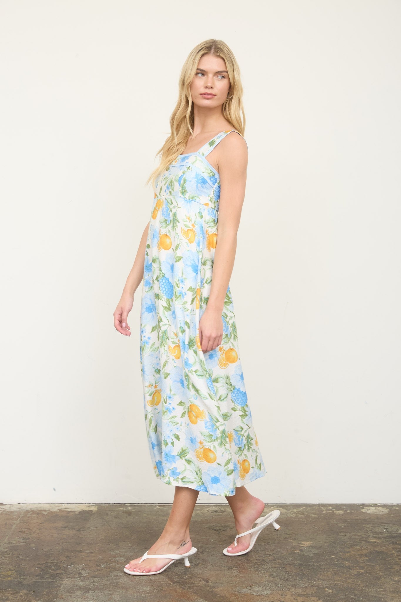 Floral Midi Dress features a sleeveless A-line silhouette, square neckline, and playful floral-and-fruit pattern