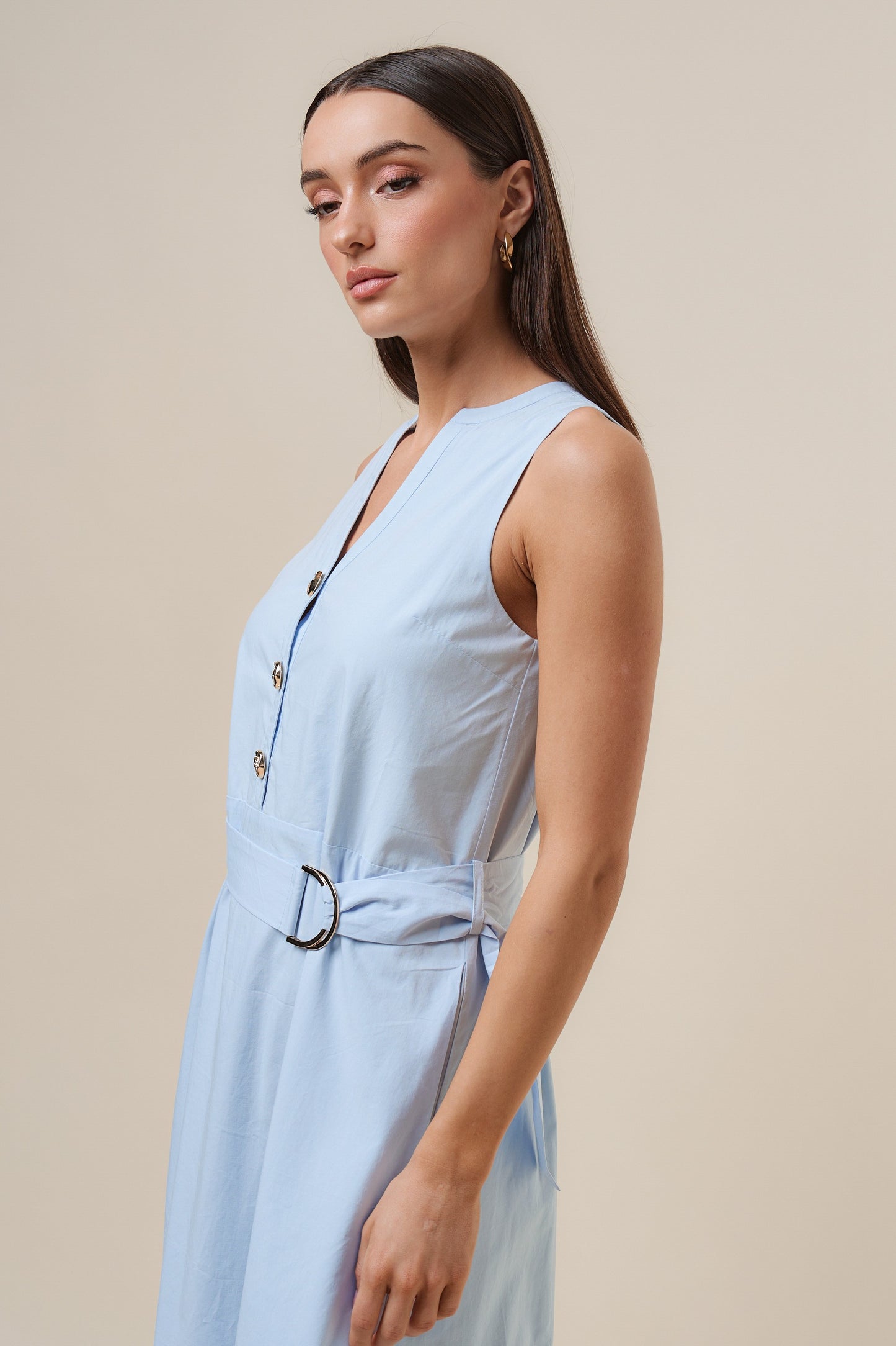 D-Ring Maxi Dress features a sleeveless silhouette with a self-tie belt, gold metal D-ring, and button details