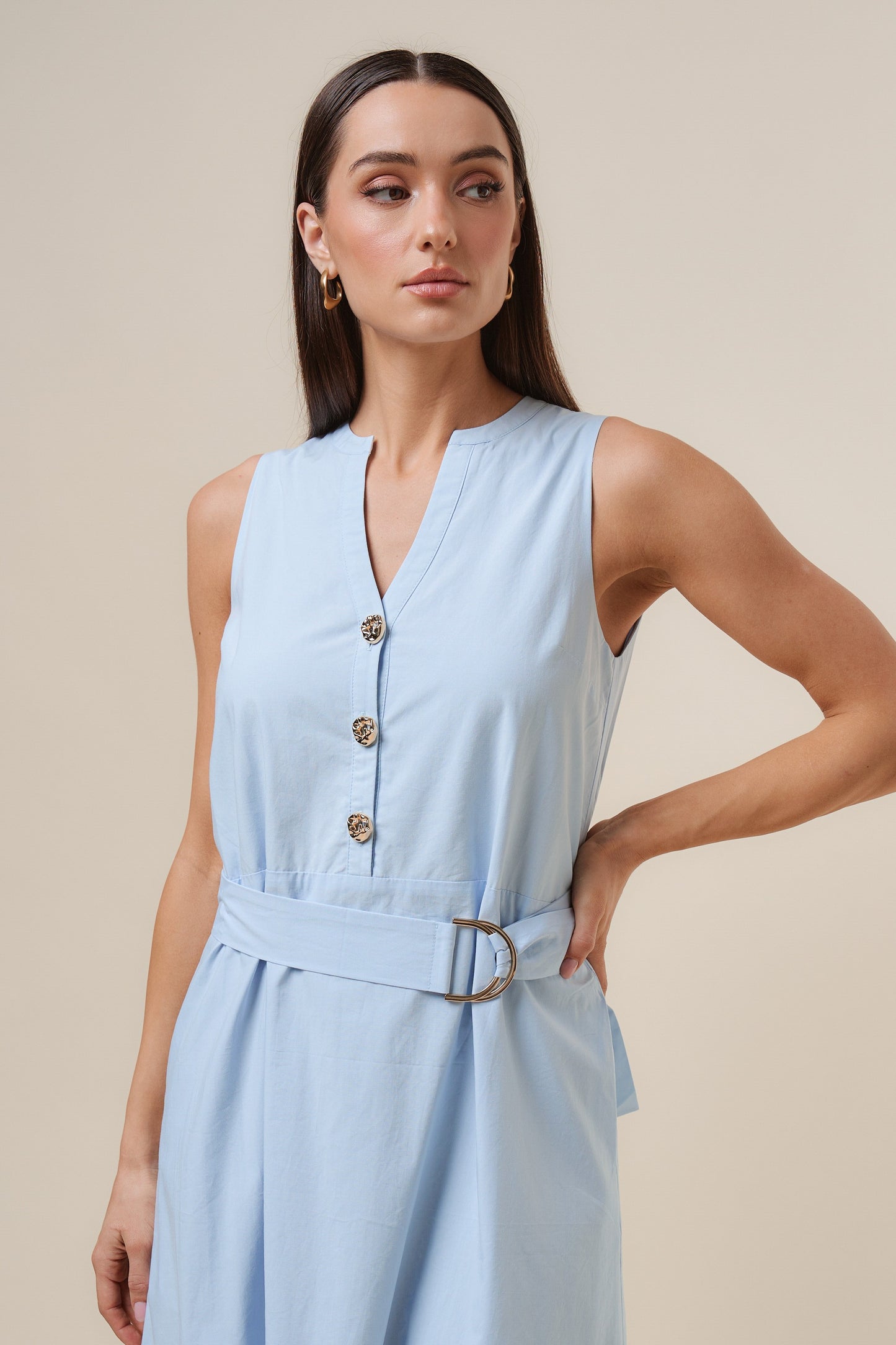 D-Ring Maxi Dress features a sleeveless silhouette with a self-tie belt, gold metal D-ring, and button details