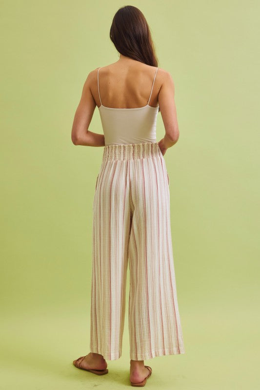 Lightweight cotton gauze wide leg pants with a smocked high-rise waist and relaxed, breezy fit.