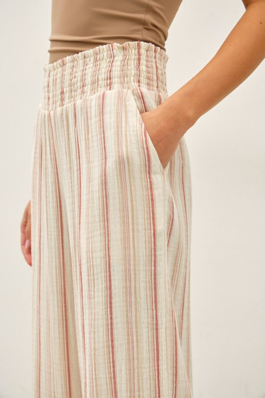 Lightweight cotton gauze wide leg pants with a smocked high-rise waist and relaxed, breezy fit.