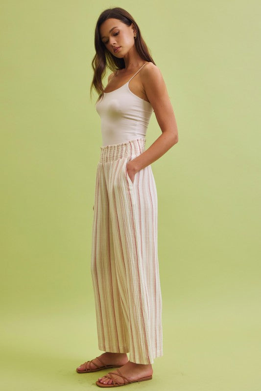 Lightweight cotton gauze wide leg pants with a smocked high-rise waist and relaxed, breezy fit.