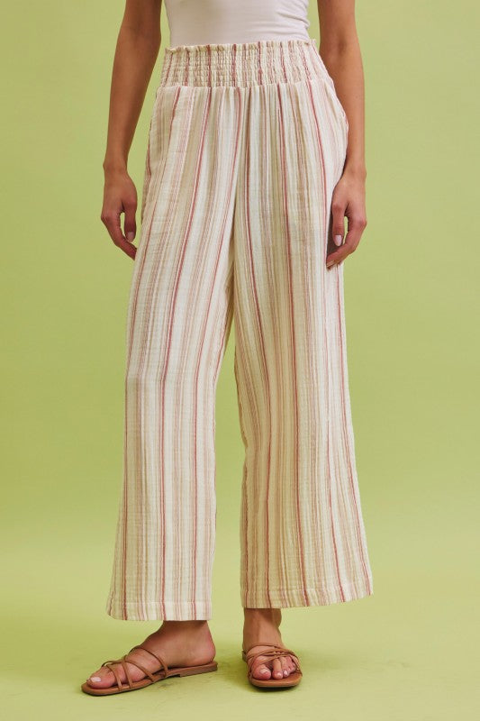 Lightweight cotton gauze wide leg pants with a smocked high-rise waist and relaxed, breezy fit.