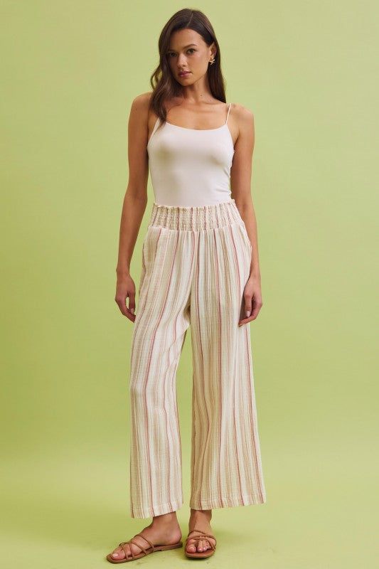 Lightweight cotton gauze wide leg pants with a smocked high-rise waist and relaxed, breezy fit.