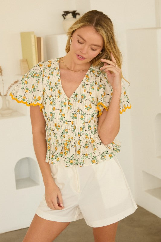 Floral Peplum Top features a flattering V-neckline, puff sleeves, and a waist-defining silhouette
