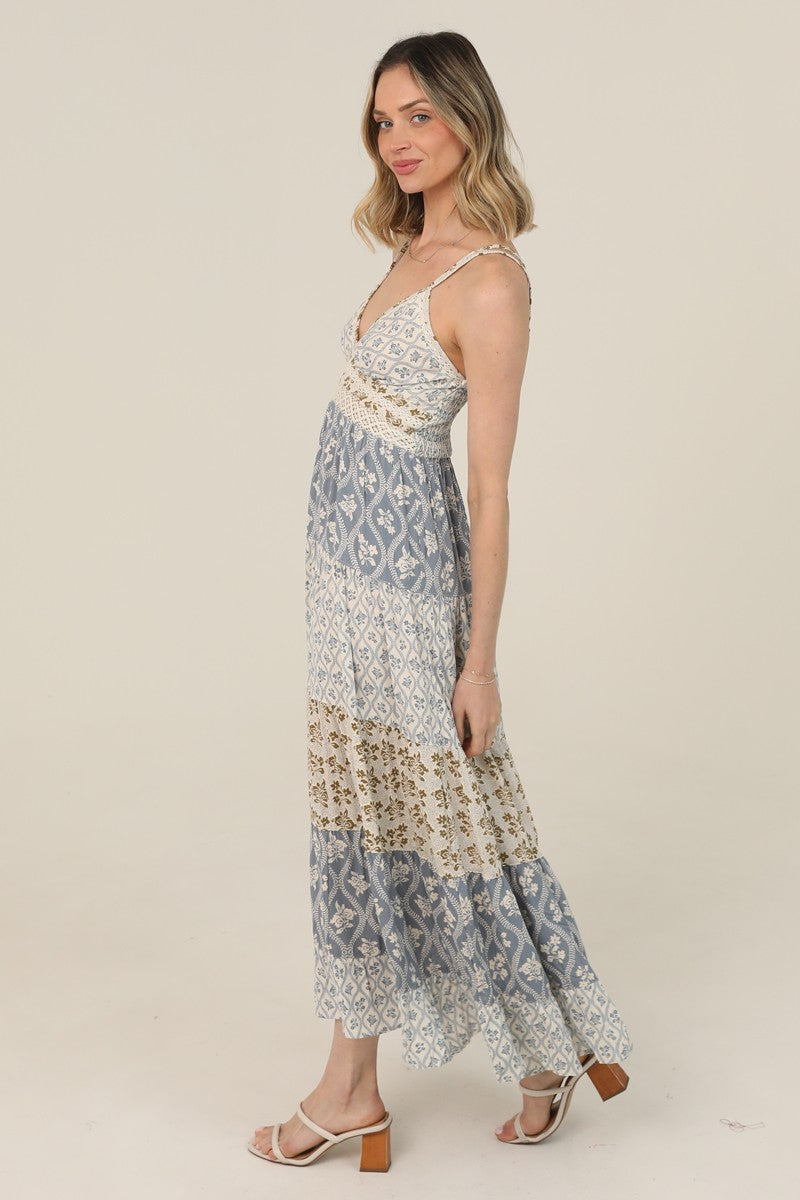  V-Neck Maxi Dress features a tiered silhouette, mixed prints, and lace trim 