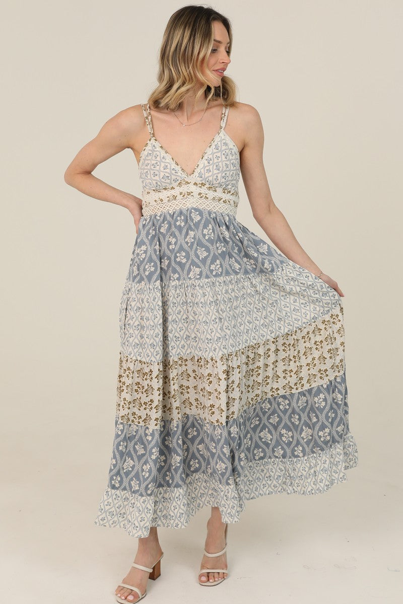  V-Neck Maxi Dress features a tiered silhouette, mixed prints, and lace trim 