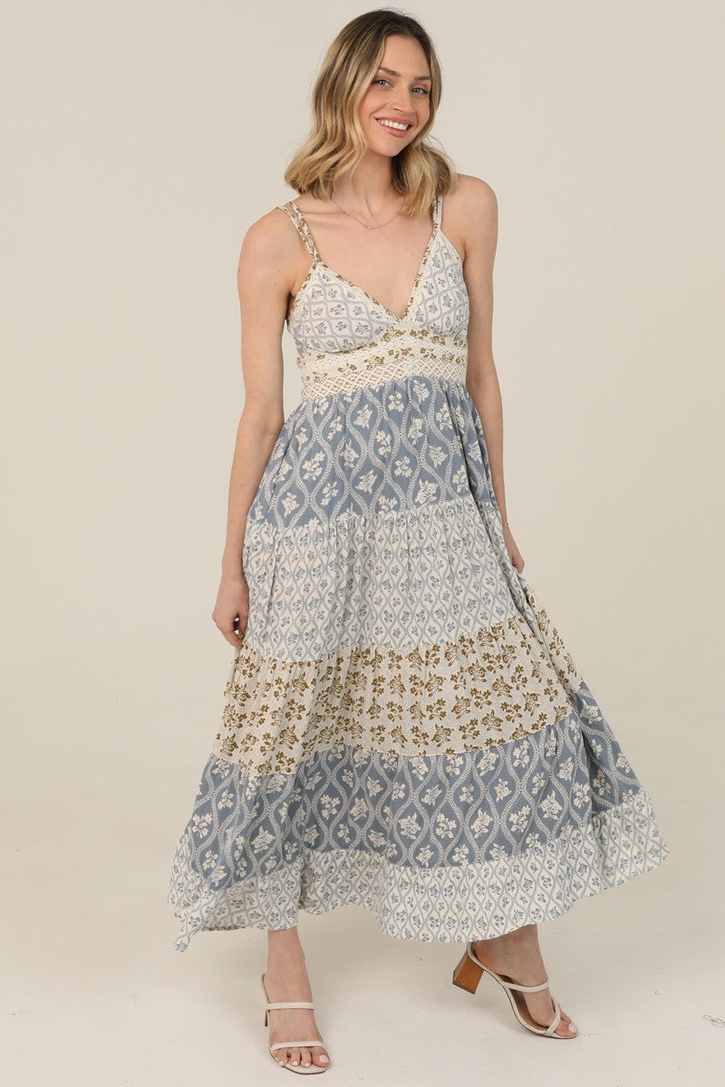  V-Neck Maxi Dress features a tiered silhouette, mixed prints, and lace trim 