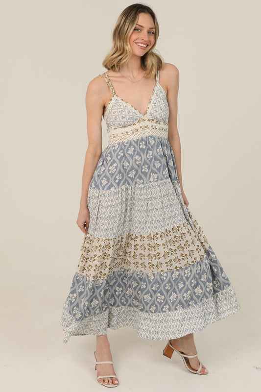  V-Neck Maxi Dress features a tiered silhouette, mixed prints, and lace trim 