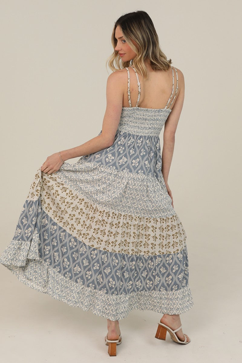  V-Neck Maxi Dress features a tiered silhouette, mixed prints, and lace trim 