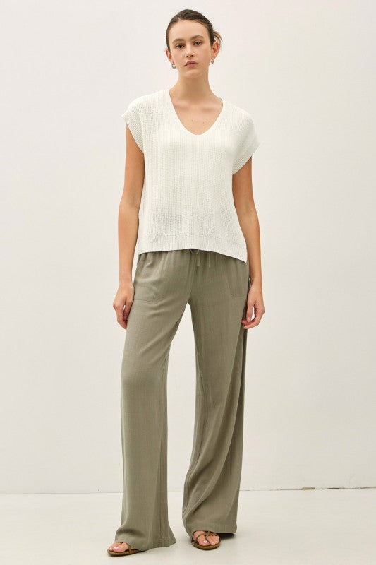 dolman sleeve V-neck sweater with a relaxed, cropped silhouette and modern high-low hem